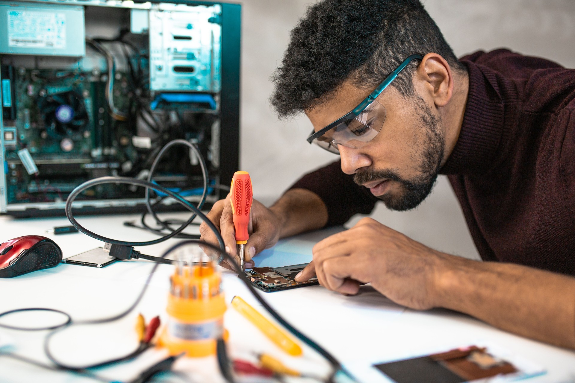 Young man repairing a technology device